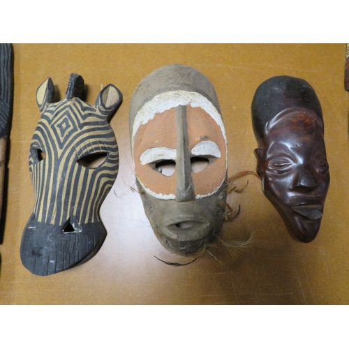 Six various African tribal art masks including one with cowrie shell eyes