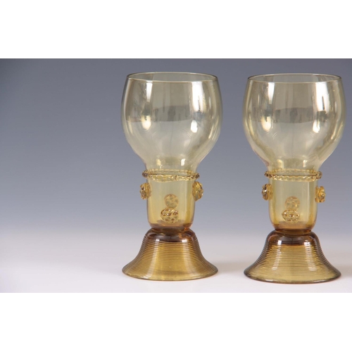 10 - A SET OF 5 CONTINENTAL PALE AMBER WINE GLASSES with rounded bowls and prunted stems on ribbed spread... 