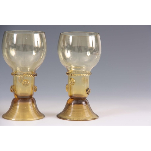 10 - A SET OF 5 CONTINENTAL PALE AMBER WINE GLASSES with rounded bowls and prunted stems on ribbed spread... 