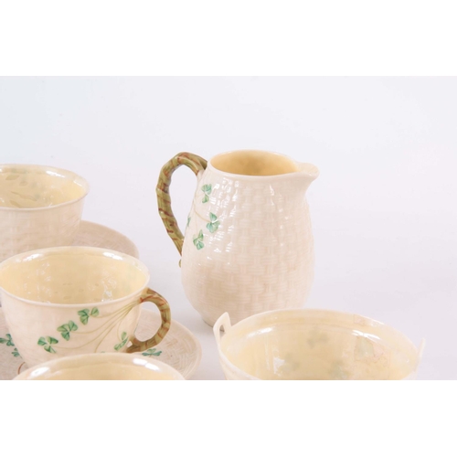 100 - A 20TH CENTURY BELLEEK PORCELAIN PART TEA SET, in a basket weave and shamrock pattern, having milk j... 