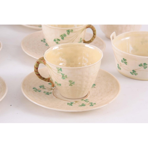 100 - A 20TH CENTURY BELLEEK PORCELAIN PART TEA SET, in a basket weave and shamrock pattern, having milk j... 