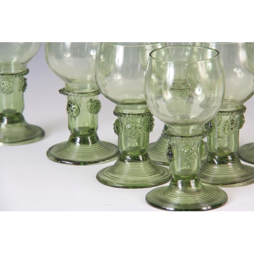 11 - A SET OF EIGHT 19TH CENTURY CONTINENTAL PALE GREEN WINE GLASSES with rounded bowls, prunted stems an... 