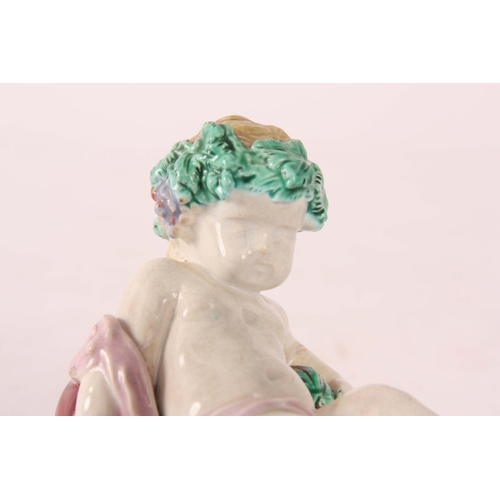 111 - A 19th Century Worcester Polychrome FIGURE of a reclining Putti 8cm high