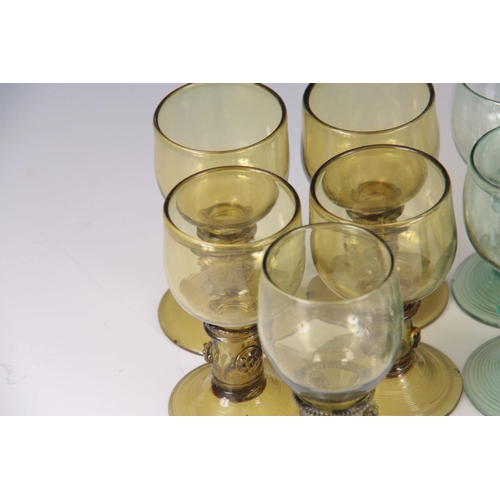 12 - A SET OF FIVE CONTINENTAL PALE AMBER WINE GLASSES with prunted stems and ribbed bases together with ... 