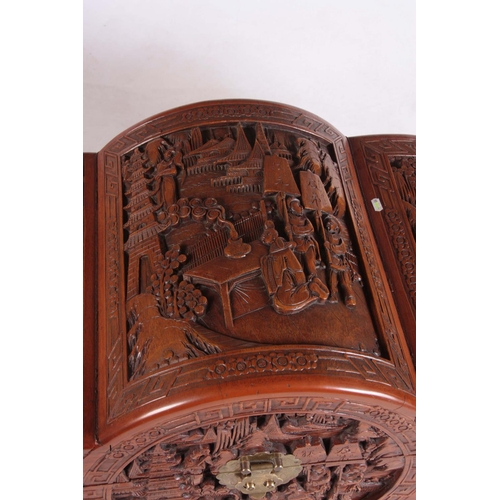 126 - A CARVED CHINESE HARDWOOD SHAPED BLANKET BOX decorated with figures amongst trees and galleons 102cm... 