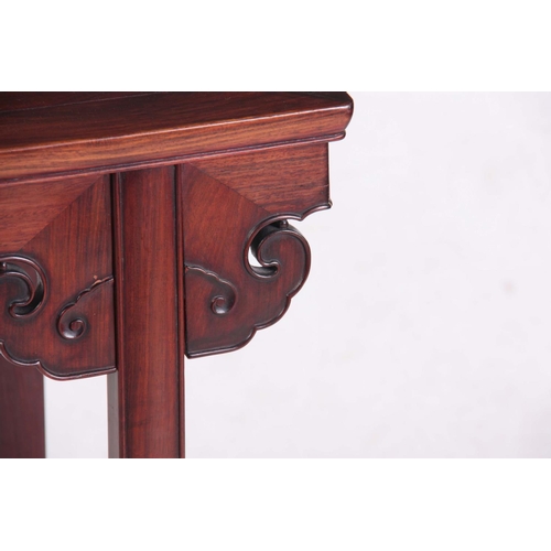 129 - A 19TH CENTURY CHINESE HARDWOOD OCCASIONAL TABLE with shaped carved frieze; standing on square legs ... 