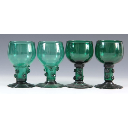 13 - A MATCHED SET OF FOUR 19TH CENTURY BRISTOL GREEN WINE GLASSES with rounded bowls continuing downward... 