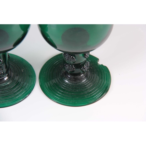 13 - A MATCHED SET OF FOUR 19TH CENTURY BRISTOL GREEN WINE GLASSES with rounded bowls continuing downward... 