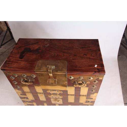 130 - AN 18TH CENTURY CHINESE ELM CHEST with brass mounted decorated front and hinged lock plate; standing... 