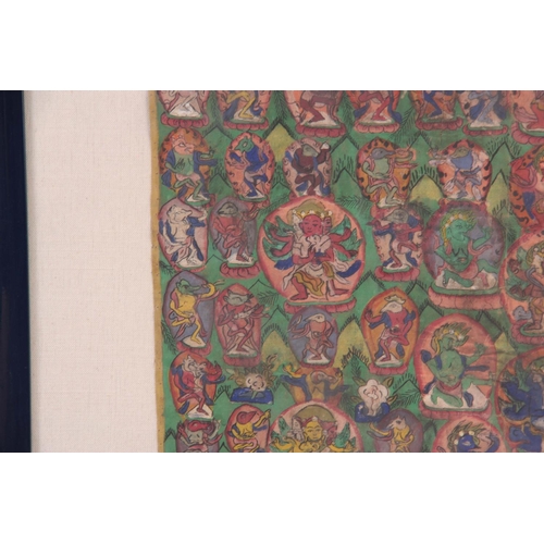 132 - AN INTERESTING LARGE INDIAN OIL ON CANVAS depicting Gods and buddhas - glazed modern frame 82cm high... 