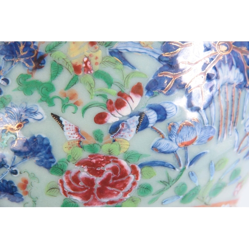 133 - A CHINESE PORCELAIN FAMILLE ROSE JARDINIéRE depicting butterflies and animals on a celadon ground.