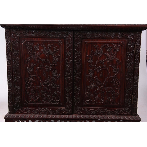 137 - AN IMPRESSIVE 19TH CENTURY CHINESE HARDWOOD DISPLAY CABINET having elaborately carved dragon pedimen... 