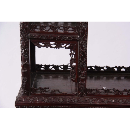 137 - AN IMPRESSIVE 19TH CENTURY CHINESE HARDWOOD DISPLAY CABINET having elaborately carved dragon pedimen... 