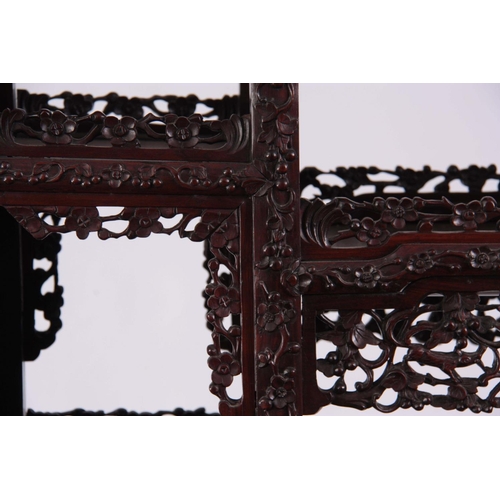 137 - AN IMPRESSIVE 19TH CENTURY CHINESE HARDWOOD DISPLAY CABINET having elaborately carved dragon pedimen... 