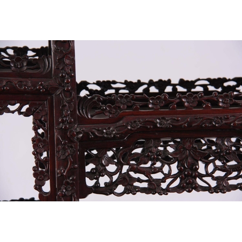 137 - AN IMPRESSIVE 19TH CENTURY CHINESE HARDWOOD DISPLAY CABINET having elaborately carved dragon pedimen... 