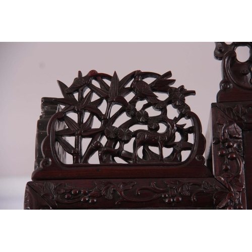 137 - AN IMPRESSIVE 19TH CENTURY CHINESE HARDWOOD DISPLAY CABINET having elaborately carved dragon pedimen... 