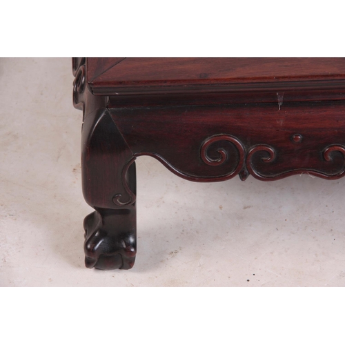 138 - A 19TH CENTURY CHINESE HARDWOOD LOW OCCASIONAL TABLE with panelled top and shaped scroll carved base... 