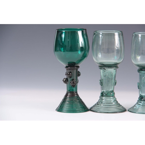 14 - A GROUP OF THREE 19TH CENTURY GREEN GLASS RUMMERS with rounded bowls on prunted flared ribbed bases ... 