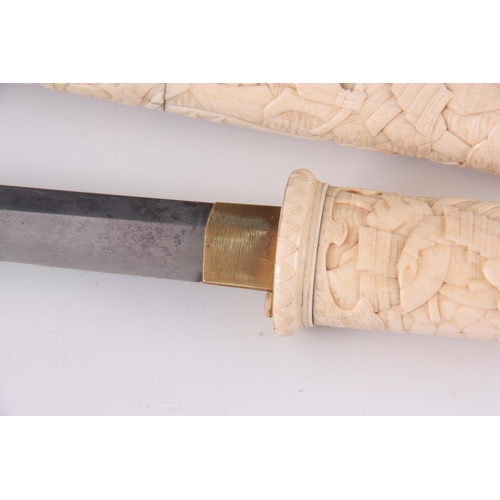 145 - A MEIJI PERIOD JAPANESE BONE TANTO the hilt and sheath profusely carved with soldiers fighting with ... 