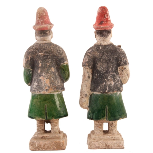 146 - A PAIR OF ORIENTAL PARTLY GLAZED TERRACOTTA TOMB ATTENDANT FIGURES each 25cm and another smaller fig... 