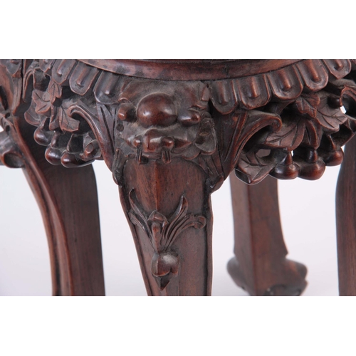 153 - A 19TH CENTURY CHINESE CARVED HARDWOOD JARDINIERE STAND with inset marble top 32cm high 28cm across.