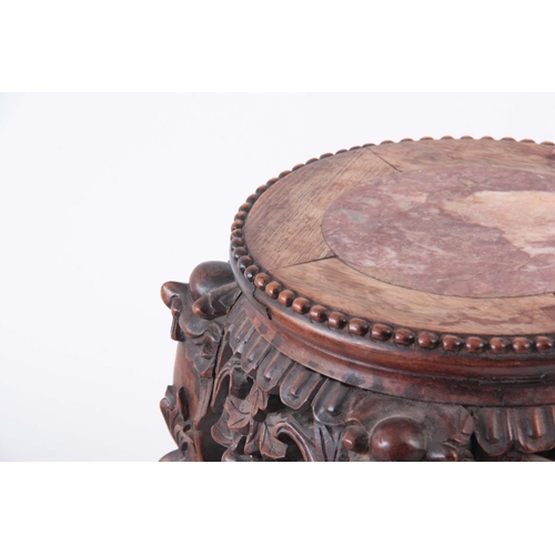 153 - A 19TH CENTURY CHINESE CARVED HARDWOOD JARDINIERE STAND with inset marble top 32cm high 28cm across.