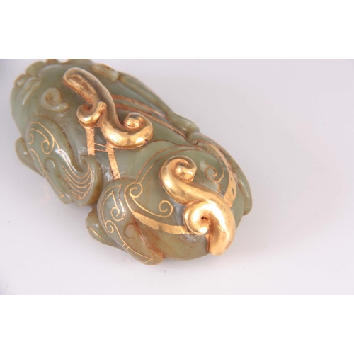 159 - A CHINESE JADE AND GILT SCULPTURE modelled as a crouching Foo dog 8.5cm long