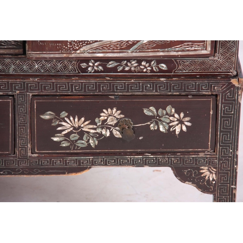 164 - AN EARLY 20TH CENTURY CHINOISERIE DECORATED LAQUERED CABINET having three sections the top two with ... 