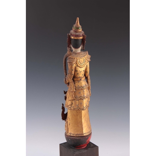 174 - A CARVED STATUE OF A WOODEN BUDDHA 69cm high.