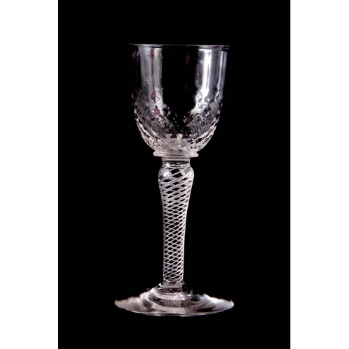 19 - AN UNSUAL ENGLISH DRINKING GLASS, with multi spiral air twist stem and brambled bowl 16cm high by 7.... 