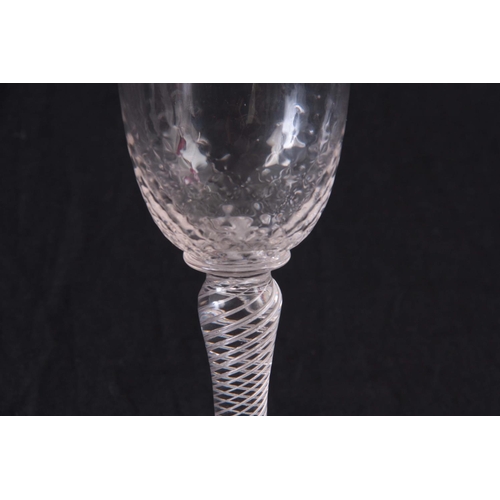 19 - AN UNSUAL ENGLISH DRINKING GLASS, with multi spiral air twist stem and brambled bowl 16cm high by 7.... 