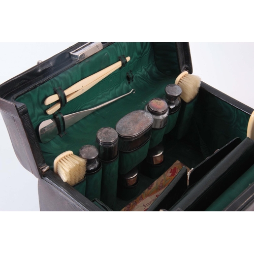 214 - A GREEN LEATHER FITTED VANITY CASE BY DREW & SONS, LONDON complete with silver mounted bottles and i... 