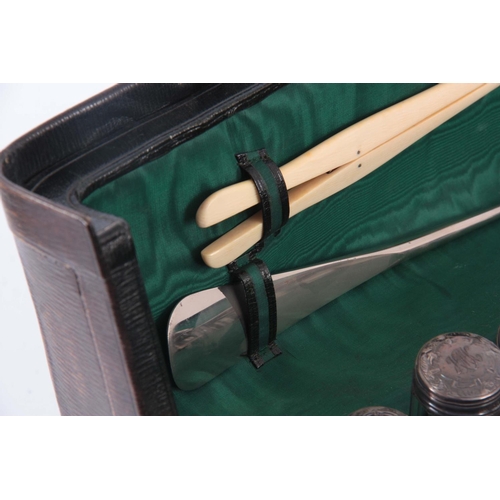 214 - A GREEN LEATHER FITTED VANITY CASE BY DREW & SONS, LONDON complete with silver mounted bottles and i... 