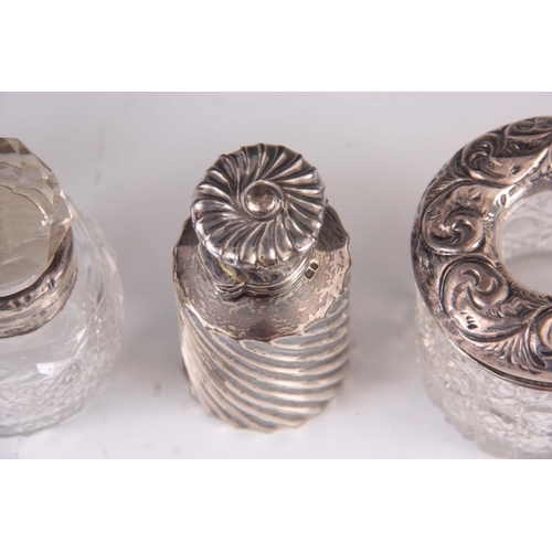 216 - A SELECTION OF 3 CUT GLASS AND SILVER BOTTLES and a silver scent bottle ( 4 )