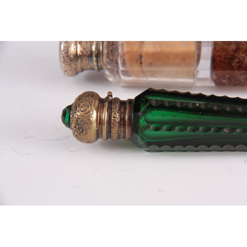 23 - A DOUBLE ENDED FACETED GLASS SCENT BOTTLE and a green cut glass scent bottle with jeweled lid, talle... 