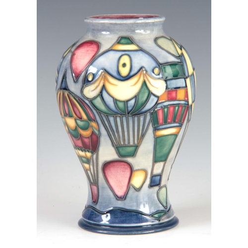 40 - A LATE 20TH CENTURY MOORCROFT POTTERY VASE decorated with a ballooning scene on a blue ground, signe... 