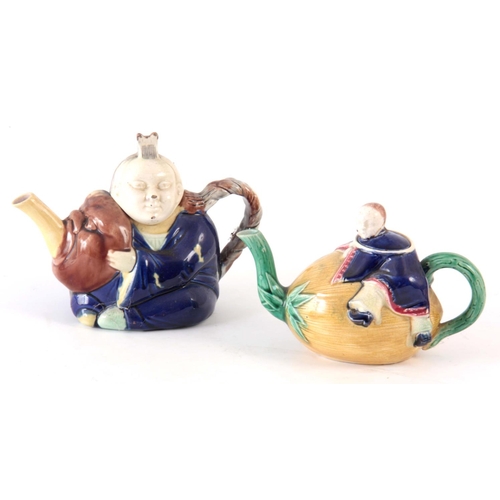 48 - TWO 19TH CENTURY MAJOLICA TEAPOTS, possibly Joseph holdcroft, one of a Chinese boy climbing on a mel... 