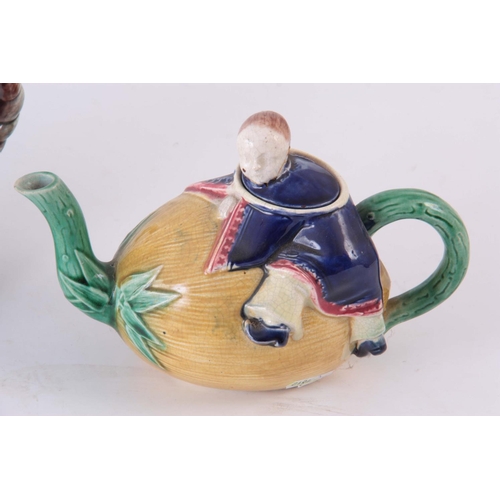 48 - TWO 19TH CENTURY MAJOLICA TEAPOTS, possibly Joseph holdcroft, one of a Chinese boy climbing on a mel... 