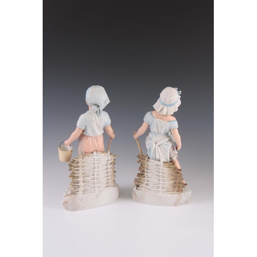 53 - A 19TH CENTURY LARGE PAIR OF BISQUE PORCELAIN FIGURES OF A BOY AND GIRL at the seaside each carrying... 