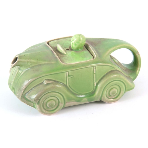 56 - A CIRCA 1930s SADLER RACING CAR TEAPOT, having a green glaze, baring registration number 820236 on t... 