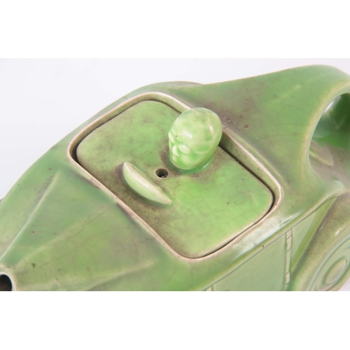 56 - A CIRCA 1930s SADLER RACING CAR TEAPOT, having a green glaze, baring registration number 820236 on t... 