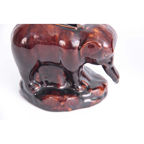 63 - A PAIR OF 19TH CENTURY TREACLE GLAZED POTTERY ELEPHANT MONEY BOXES possibly Rockingham 10cm high by ... 