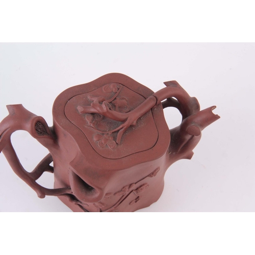 67 - AN UNUSUAL 19TH CENTURY CHINESE REDWARE TEAPOT, moulded in the form of a tree trunk with branch hand... 