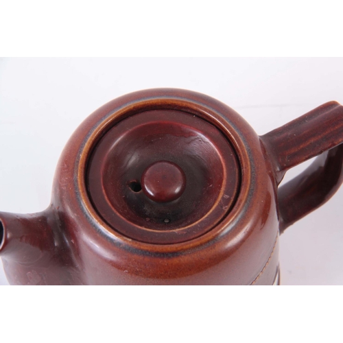 72 - AN EARLY 20TH CENTURY GNR, RAILWAY DINING CAR TEAPOT, having a treacle glaze 10cm high by 15cm wide,... 