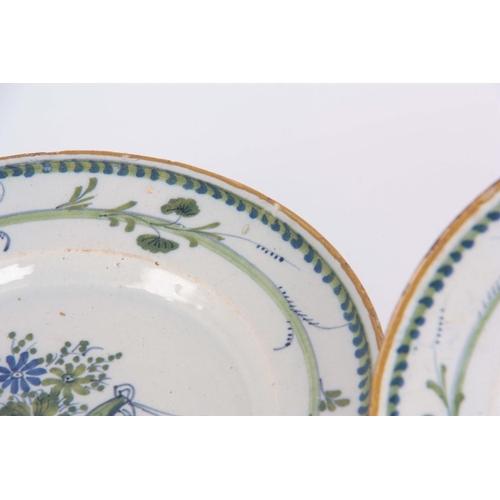 75 - A SET OF SIX 18TH CENTURY POLYCHROME DELFT PLATES in blue white and green having a yellow rim decora... 