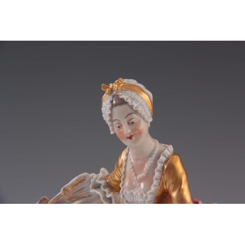 95 - A 20TH CENTURY SEVRES STYLE FIGURE OF A LADY in a gilded crinoline dress with applied roses 19.5cm h... 