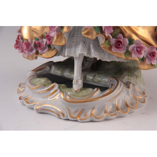 95 - A 20TH CENTURY SEVRES STYLE FIGURE OF A LADY in a gilded crinoline dress with applied roses 19.5cm h... 