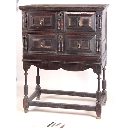 1130 - A LATE 17TH CENTURY GEOMETRIC MOULDED OAK CHEST ON STAND having three graduated drawers with side ru... 