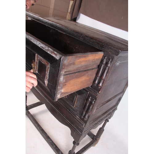 1130 - A LATE 17TH CENTURY GEOMETRIC MOULDED OAK CHEST ON STAND having three graduated drawers with side ru... 