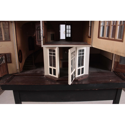 1131 - A LARGE EDWARDIAN DOLLS HOUSE fully fitted with furniture - on a stand 101cm wide 78cm deep